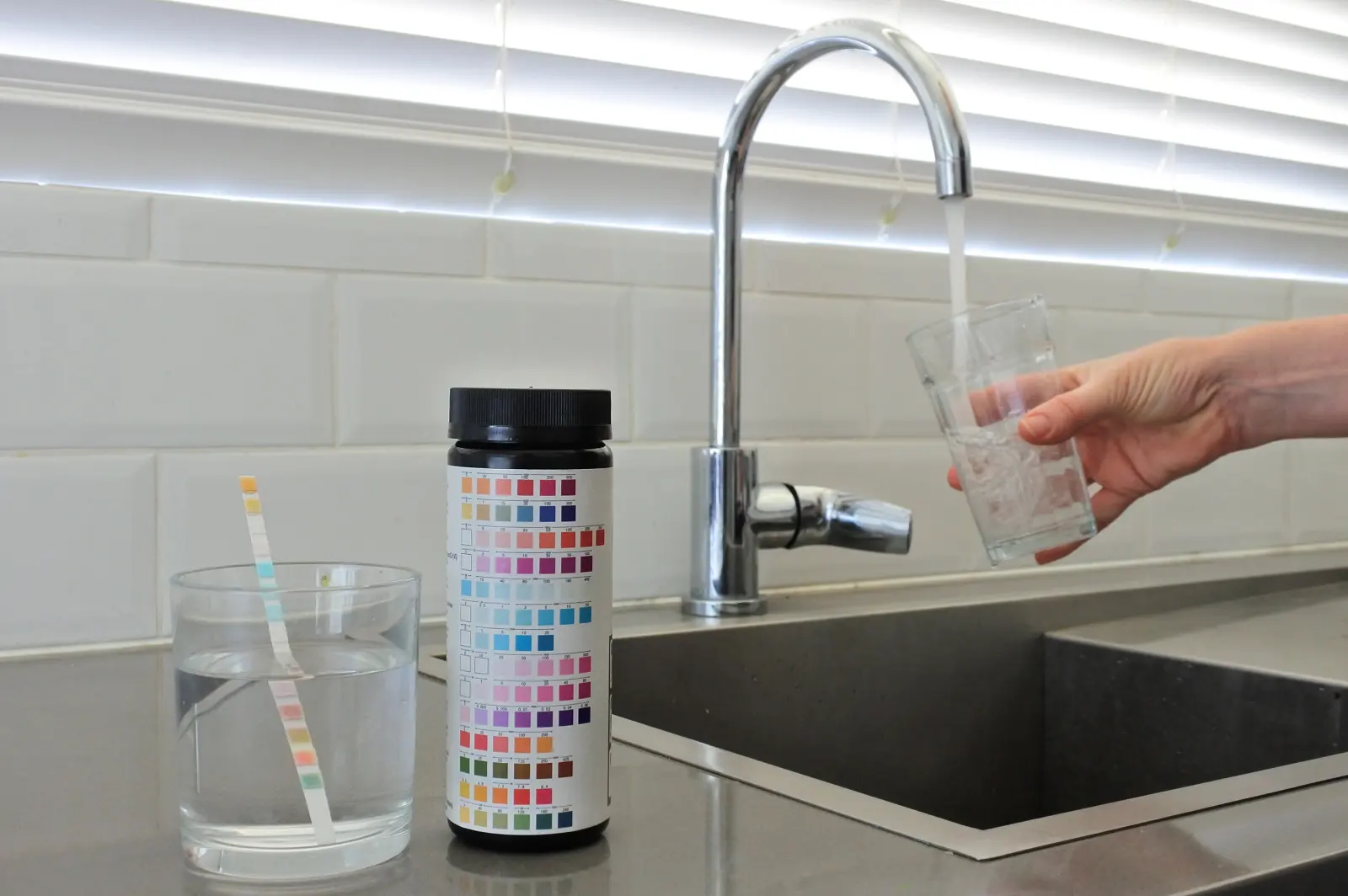Water test strips beside a kitchen sink